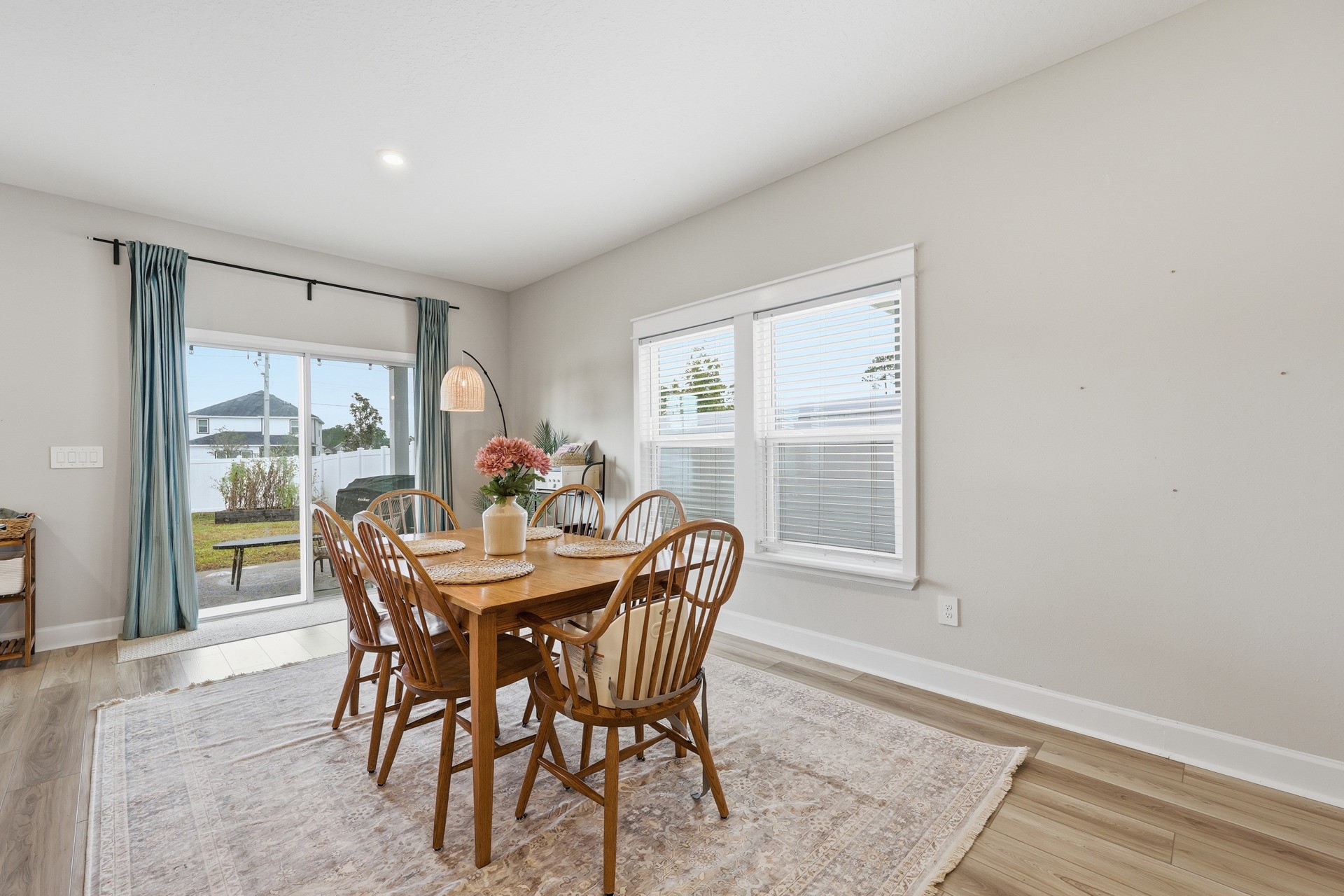 95026 Rocky Place Fernandina Beach, FL 32034 - Photo 10 of 53 a dining room with furniture a rug and a floor to ceiling window