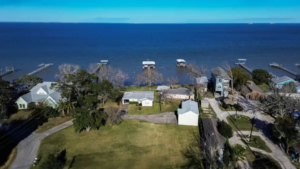 an aerial view of a house with swimming pool and patio