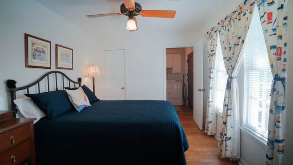 a bedroom with a bed and wooden floor