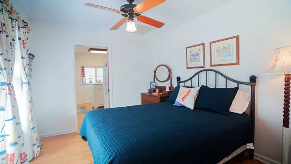a bedroom with furniture and wooden floor