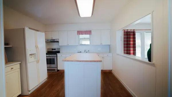 a kitchen with a refrigerator and a sink