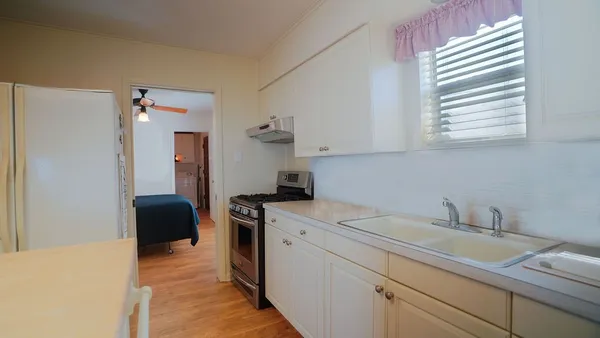 a view of a kitchen with sink dishwasher and furniture