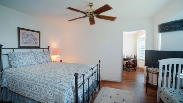 a bedroom with a bed and a chandelier