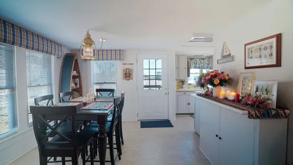 a view of a dining room with furniture and chandelier
