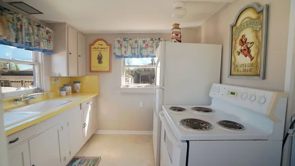 a utility room with cabinets washer and dryer