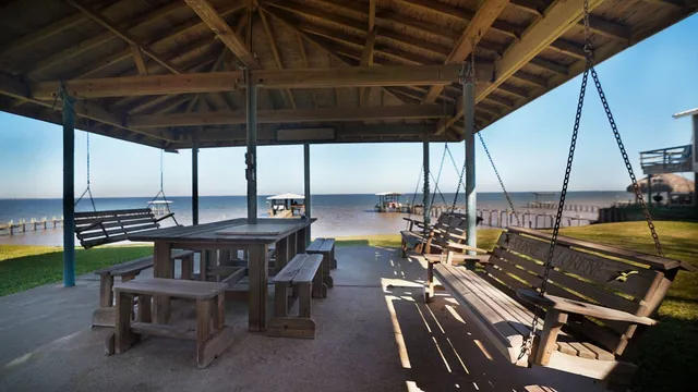 a view of a roof deck with table and chairs with wooden floor