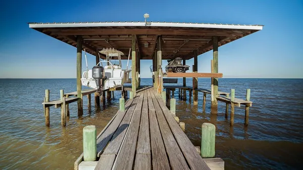 a roof deck view with table and chairs