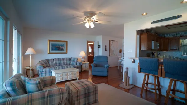 a living room with a couch and a bookshelf