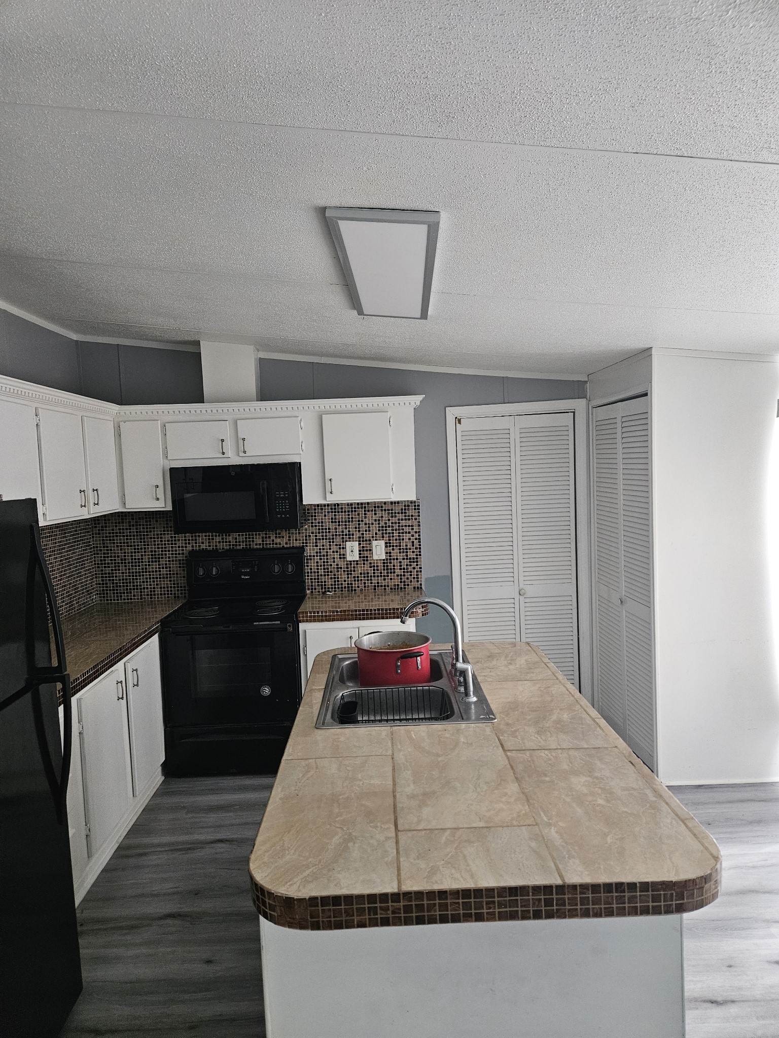 1610 Texas Street Alvin, TX 77511 - Photo 19 of 22 a kitchen with stainless steel appliances granite countertop a sink stove and cabinets