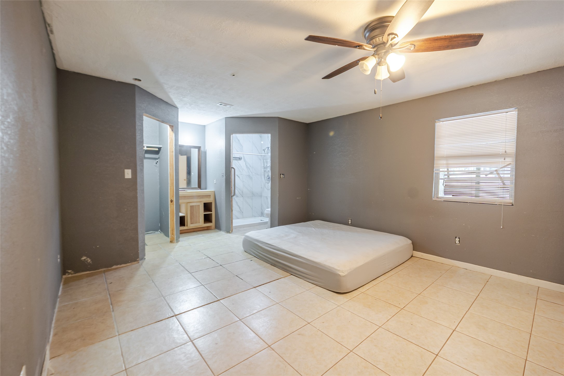 800 Butler Drive Cleveland, TX 77328 - Photo 11 of 11 a bedroom with a bed and a chandelier