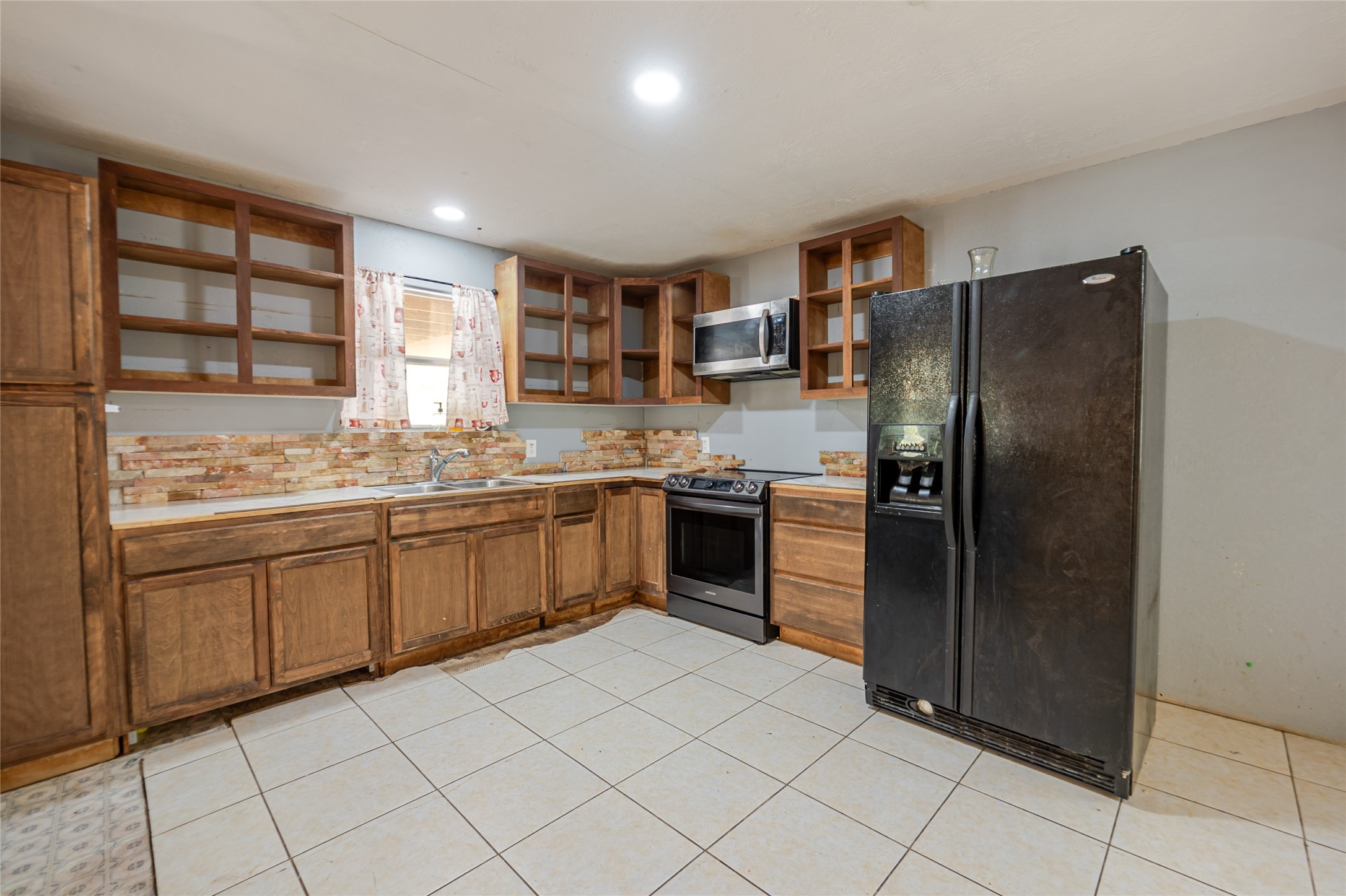 800 Butler Drive Cleveland, TX 77328 - Photo 6 of 11 a kitchen with stainless steel appliances granite countertop a refrigerator and a sink