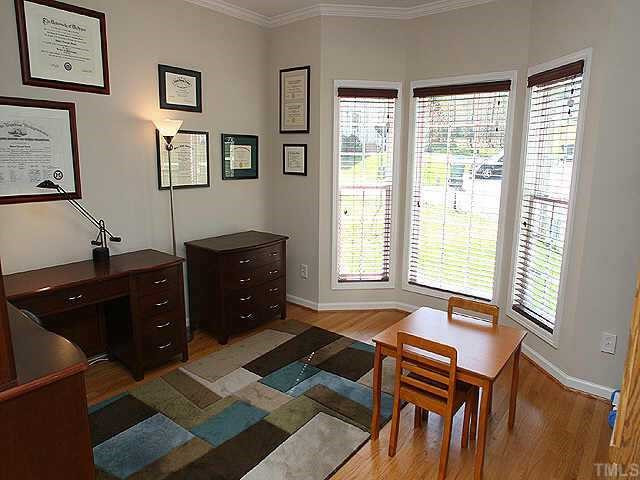 7 Providence Ridge Road Durham, NC 27713 - Photo 2 of 12 Living room with hardwood floors, crown molding, and beautiful bay window for extended space and plenty of natural light. Flexible space that can be lovely office space, traditional living room or music room. Other