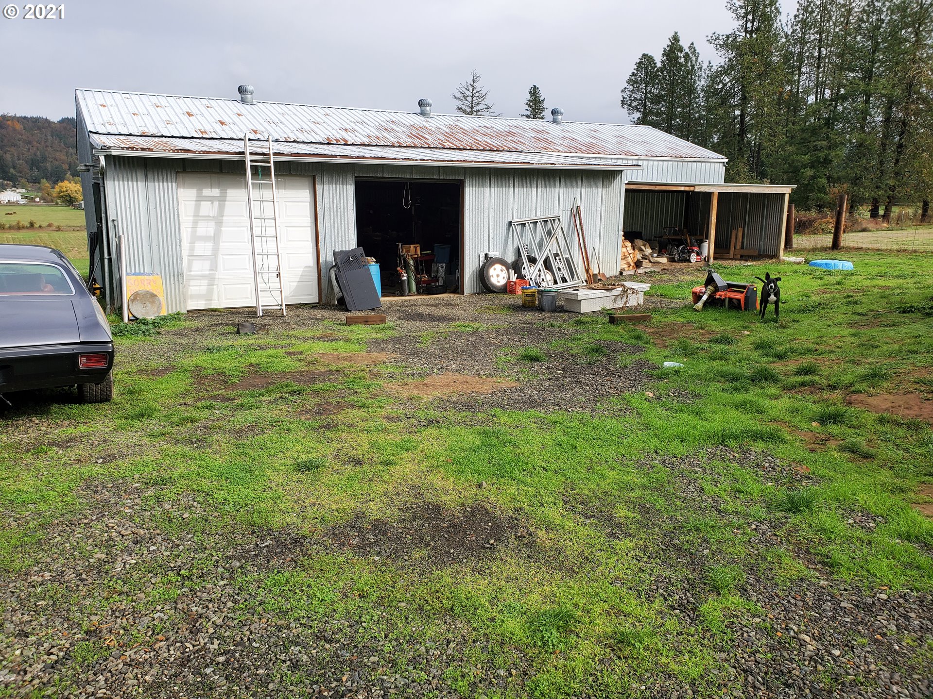732 Valley View Road Sutherlin, OR 97479 - Photo 10 of 16 a view of a patio with table and chairs under an umbrella