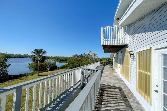 a view of a balcony with chairs and wooden floor