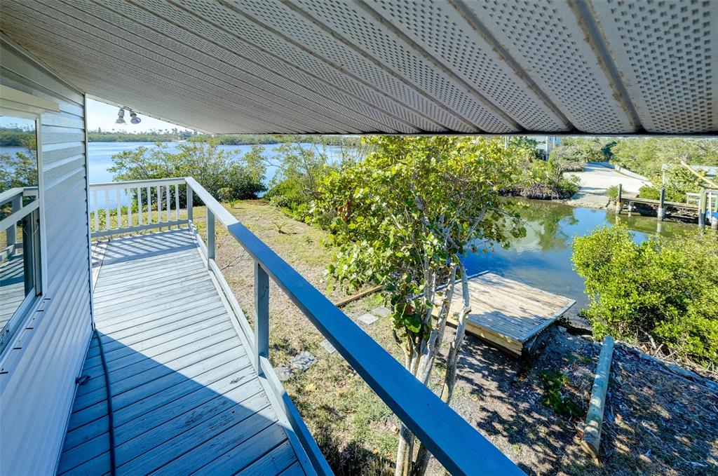 145 Burns Road Terra Ceia, FL 34250 - Photo 16 of 65 a view of a balcony with chairs and wooden floor