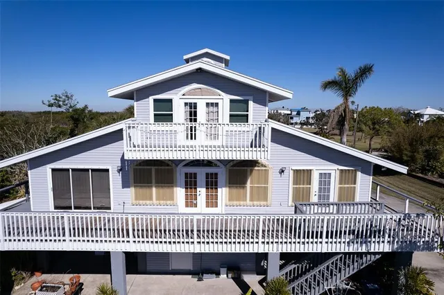 a living room with furniture a piano and a bookshelf