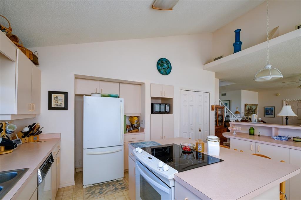 145 Burns Road Terra Ceia, FL 34250 - Photo 56 of 65 a kitchen with a refrigerator and a stove top oven