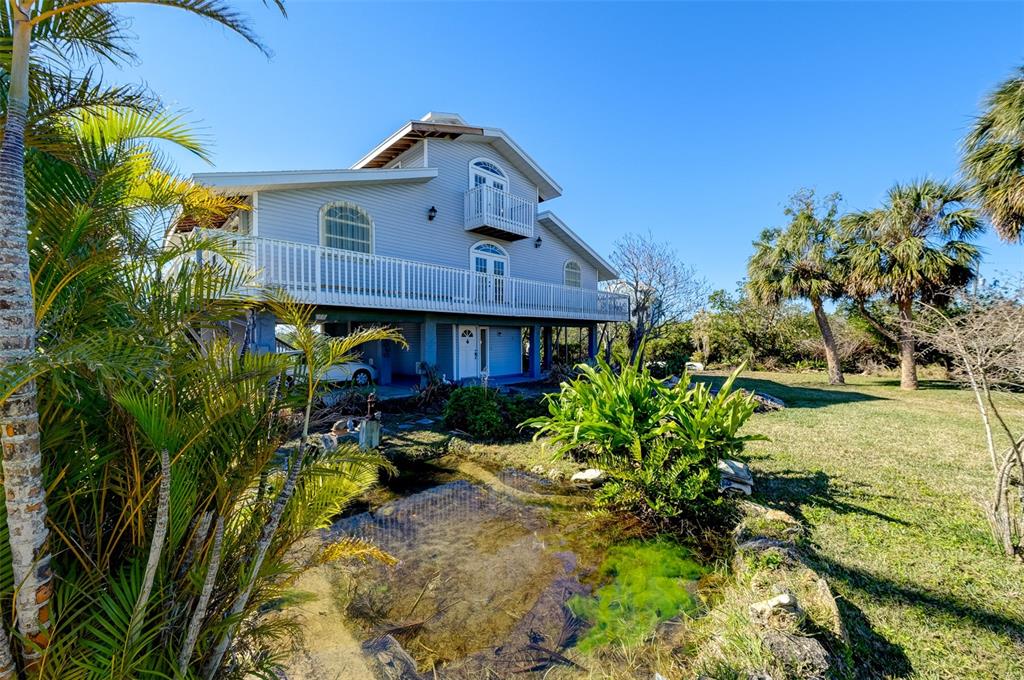 145 Burns Road Terra Ceia, FL 34250 - Photo 6 of 65 a front view of a house with garden