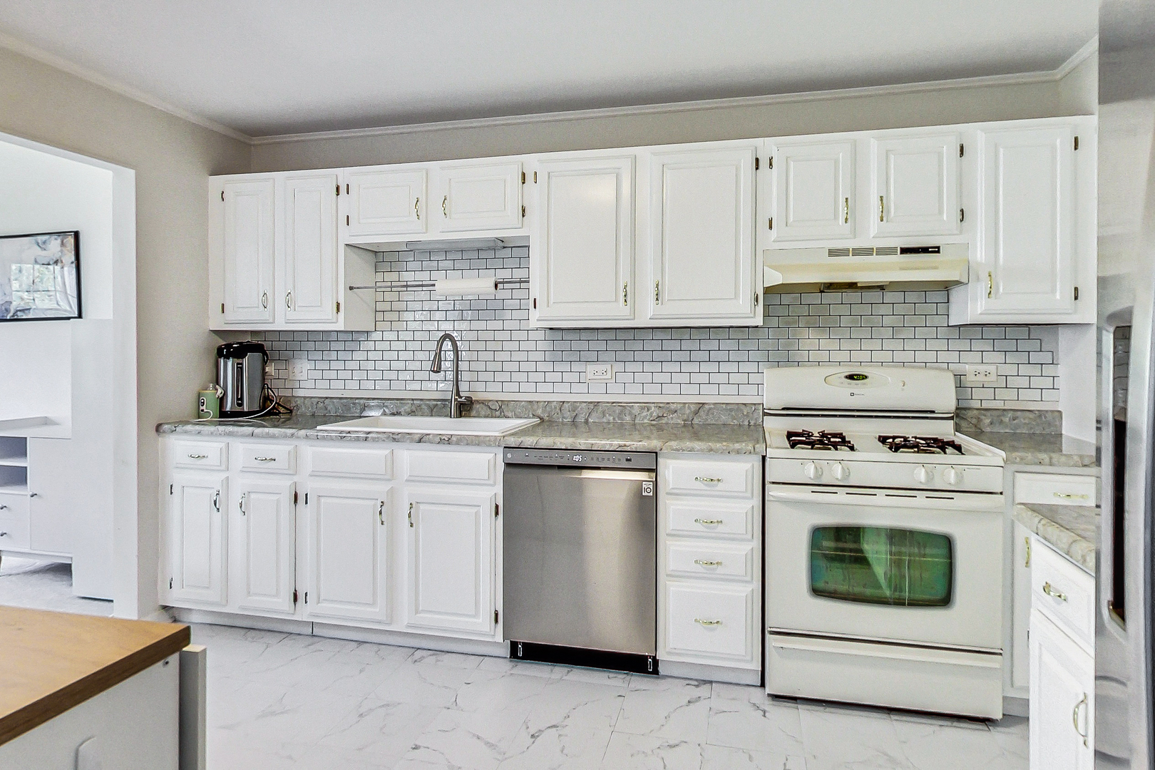 816 Butternut Lane, Unit C Mount Prospect, IL 60056 - Photo 12 of 32 a kitchen with cabinets appliances and a sink