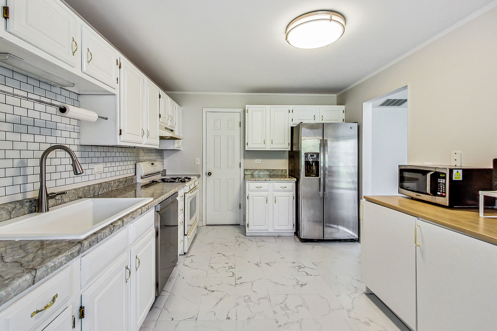 816 Butternut Lane, Unit C Mount Prospect, IL 60056 - Photo 13 of 32 a kitchen with a sink cabinets and stainless steel appliances