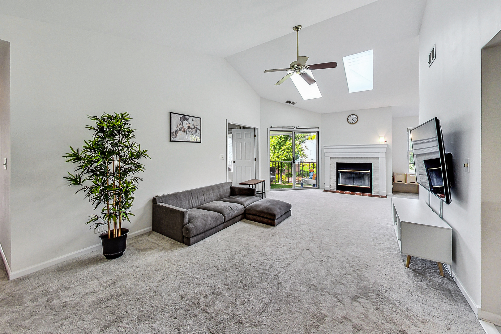 816 Butternut Lane, Unit C Mount Prospect, IL 60056 - Photo 5 of 32 a living room with furniture a fireplace and a flat screen tv