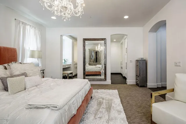 a en suite bathroom with a tub double sink and glass door