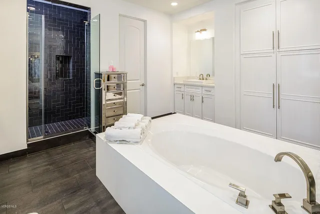 a room with lots of books and a large tree