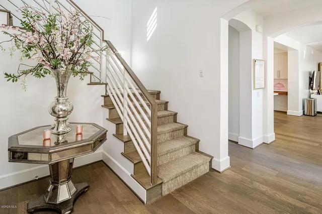 a view of entryway and hall with wooden floor