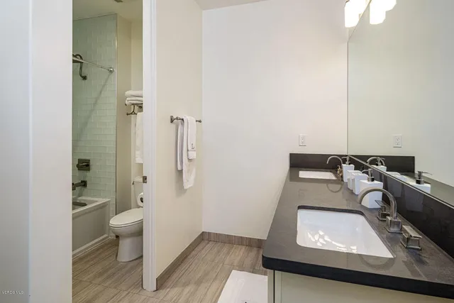 a view of a patio with couches table and chairs and potted plants