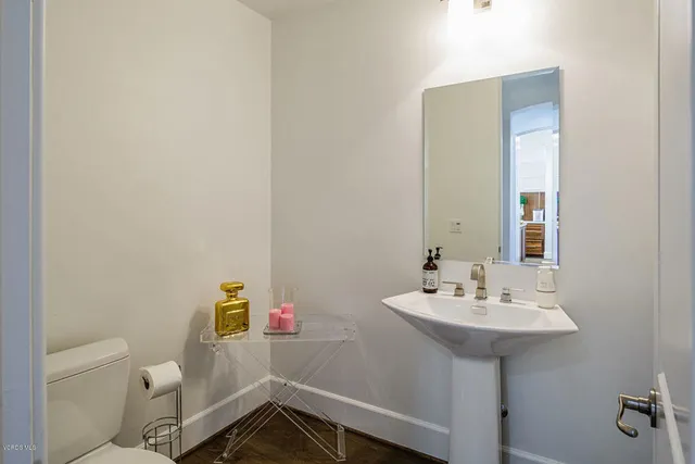 a view of a patio with couches table and chairs and potted plants