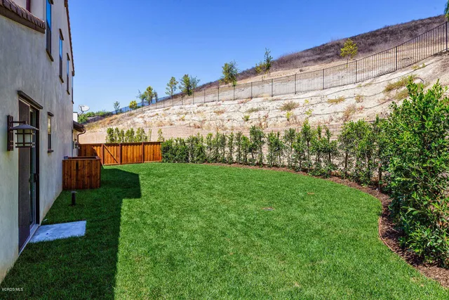a bedroom with furniture and a large window