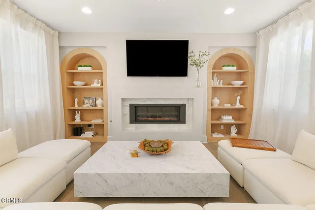 a spacious bedroom with a bed and a fireplace