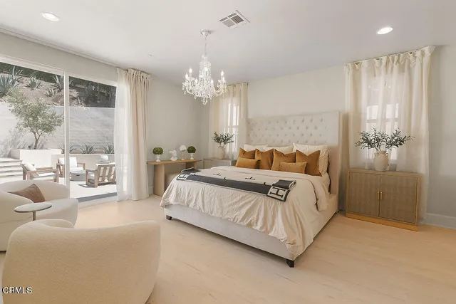 a spacious bedroom with a bed and a mirror