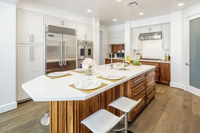 a large kitchen with a table and chairs