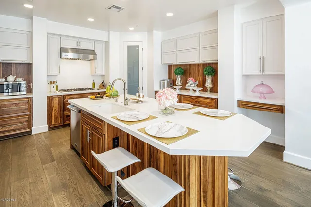 a view of a kitchen area with furniture and wooden floor