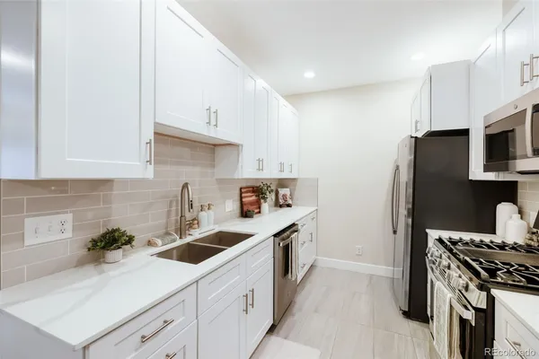 a kitchen that has a sink and a stove