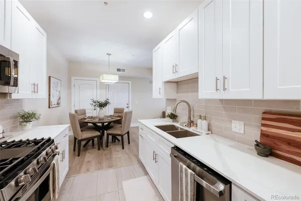 a kitchen with a sink stove and cabinets