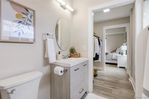 a en suite bathroom with a sink mirror and toilet
