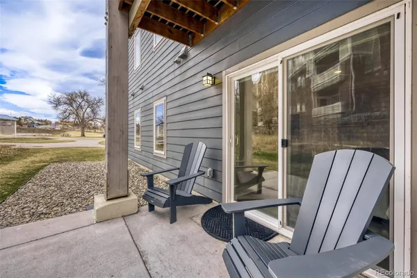 a view of a balcony with chair and floor to ceiling window yard