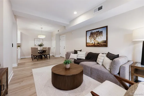 a living room with furniture and wooden floor