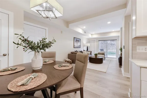 a living room with furniture potted plant and a chandelier