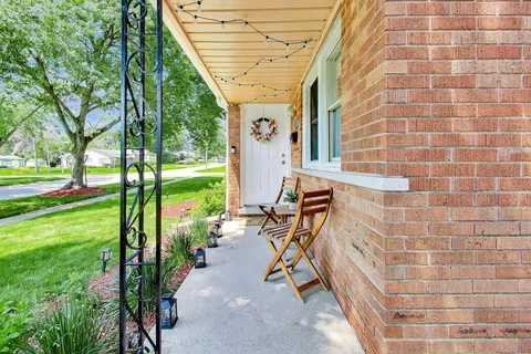 a view of a patio with chairs and a table