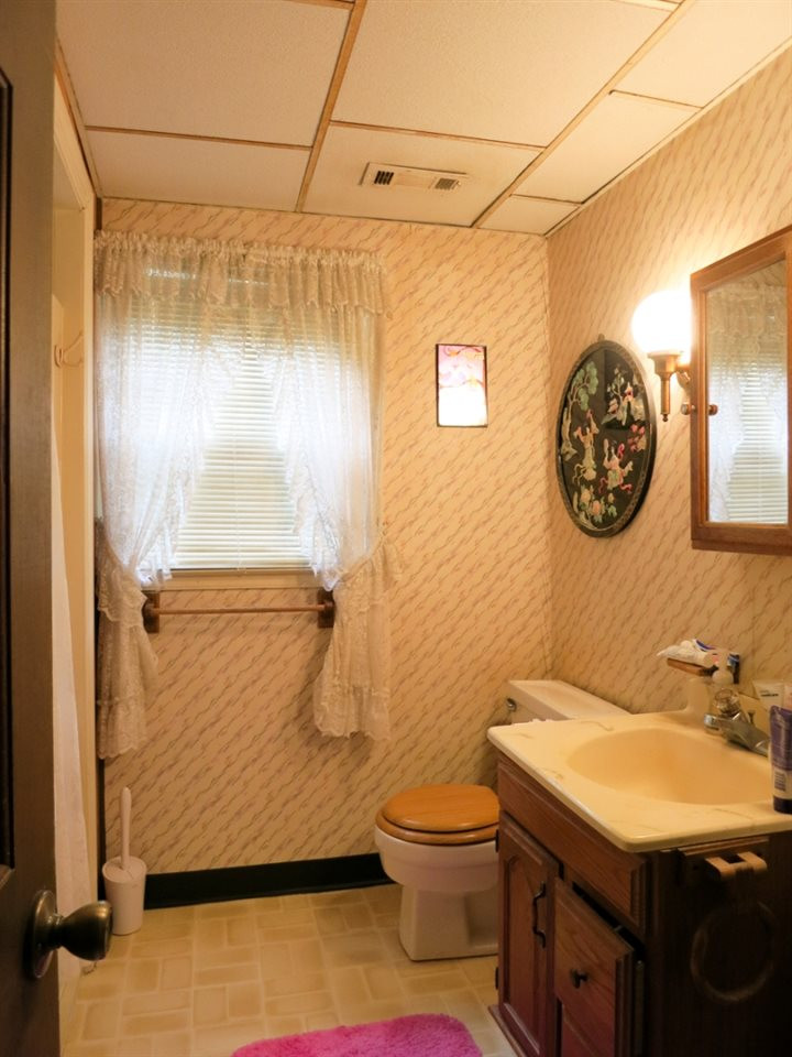 613 Compton Road Raleigh, NC 27609 - Photo 20 of 25 View of the Lower Level full Bath w/neutral vinyl flr & lg shower. Bathroom