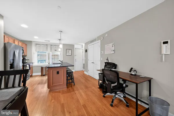 a view of a workspace with furniture and a window