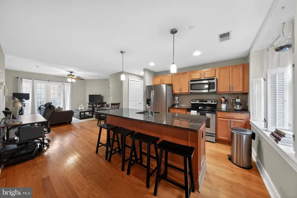 a large kitchen with a table and chairs