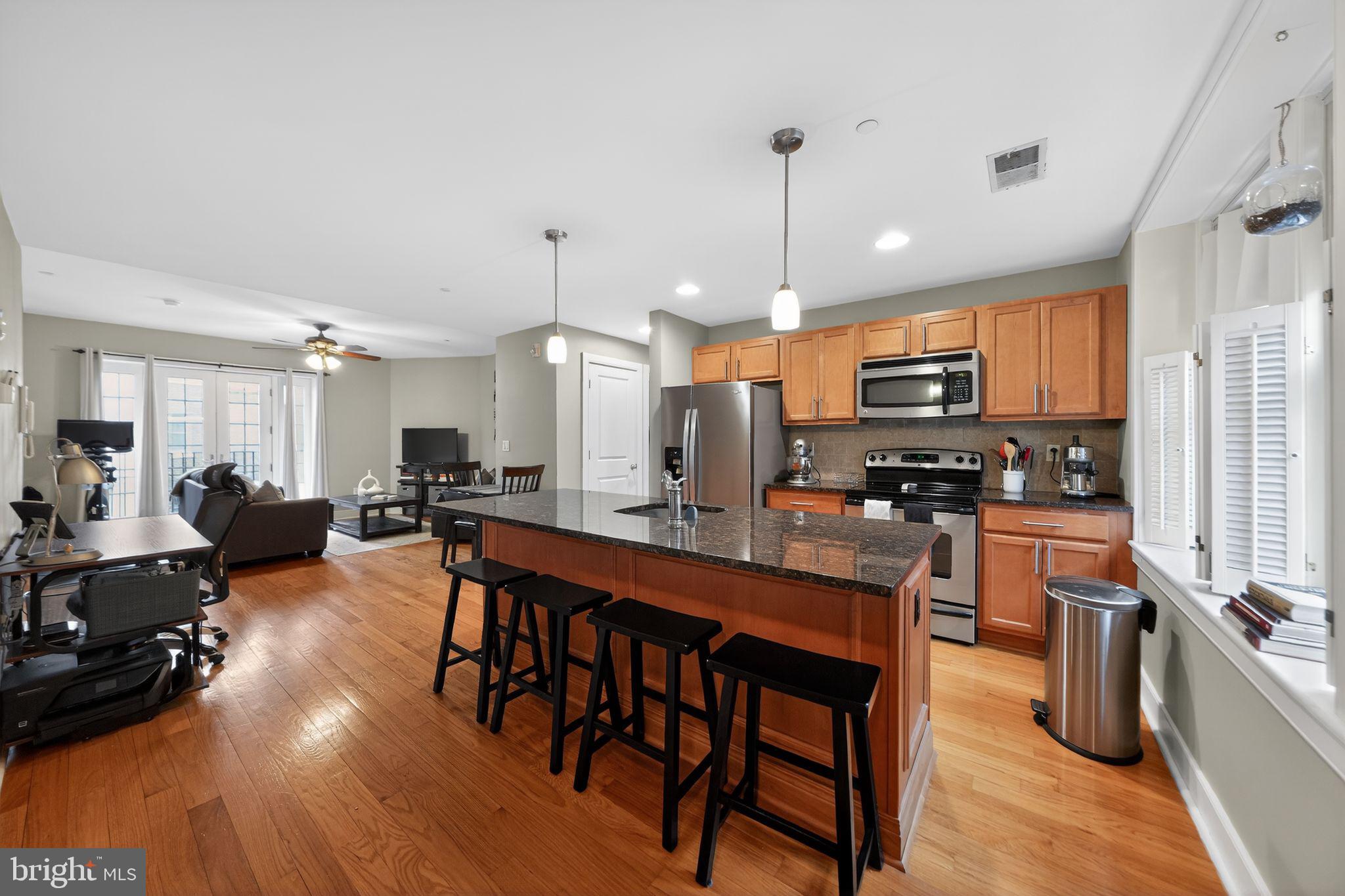 4300 Spruce Street, Unit B304 Philadelphia, PA 19104 - Photo 15 of 26 a large kitchen with a table and chairs