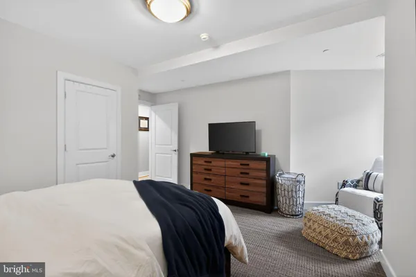 a bedroom with furniture and flat screen tv