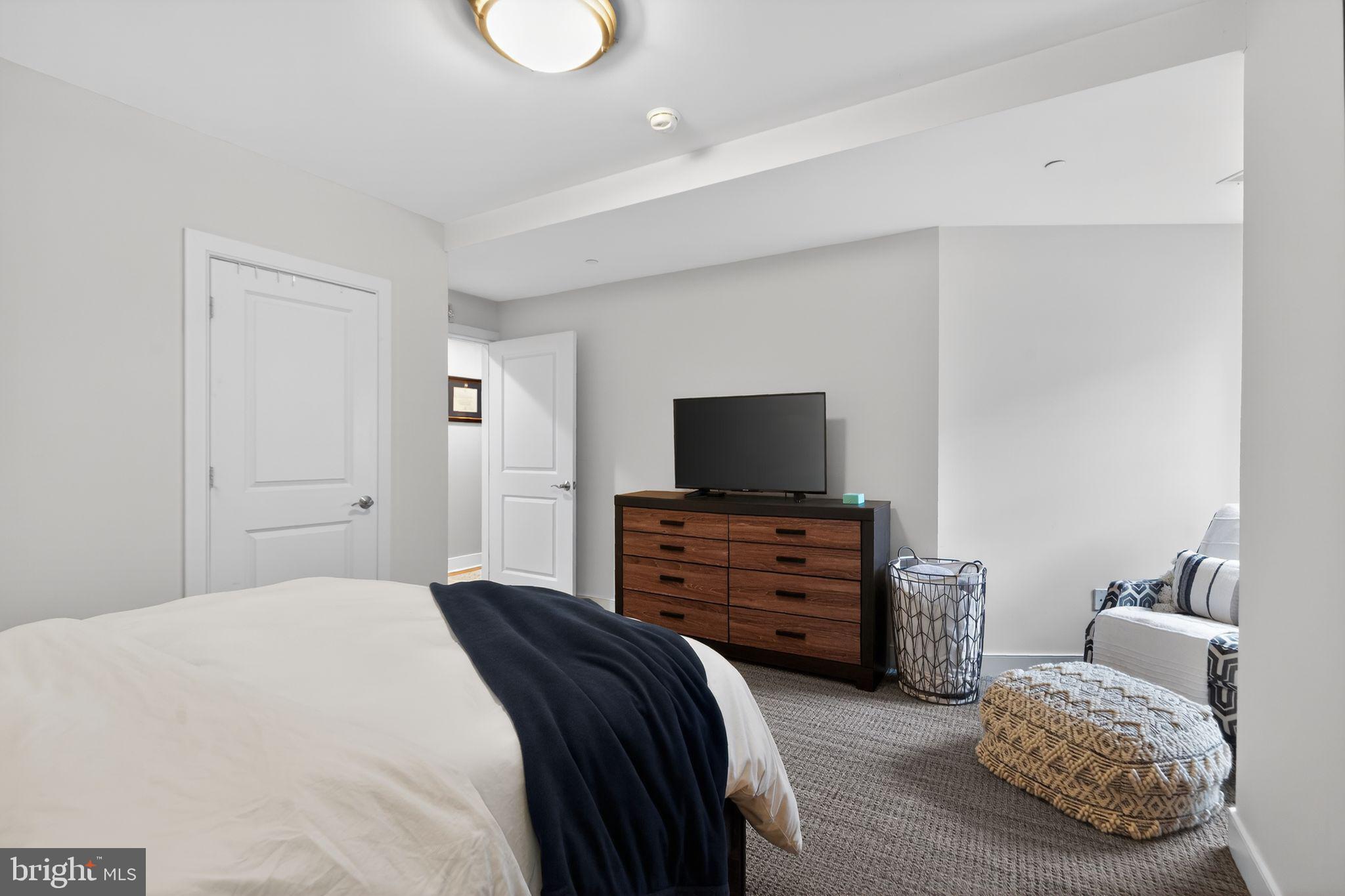 4300 Spruce Street, Unit B304 Philadelphia, PA 19104 - Photo 19 of 26 a bedroom with furniture and flat screen tv