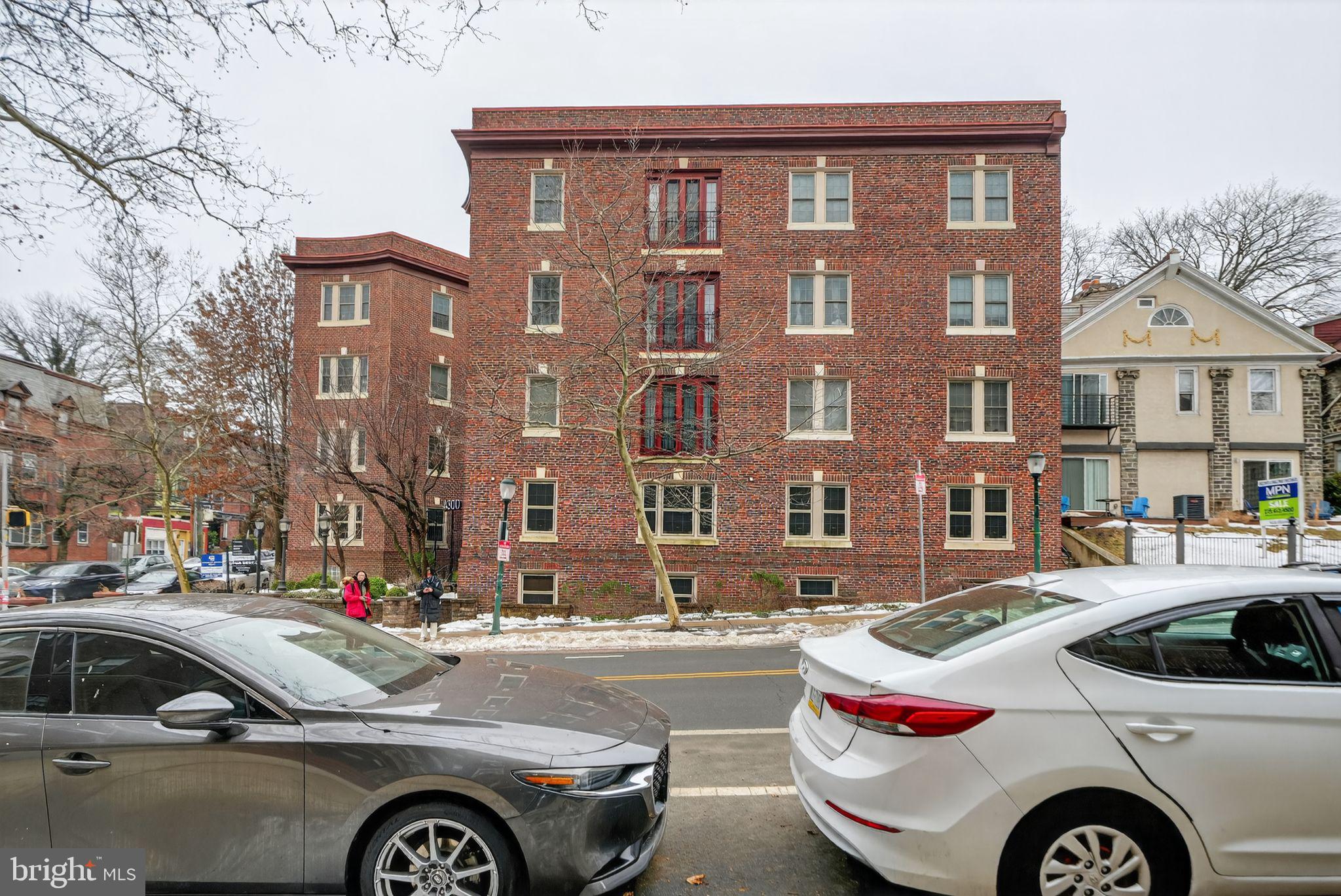 4300 Spruce Street, Unit B304 Philadelphia, PA 19104 - Photo 25 of 26 a front view of a residential apartment building with a yard