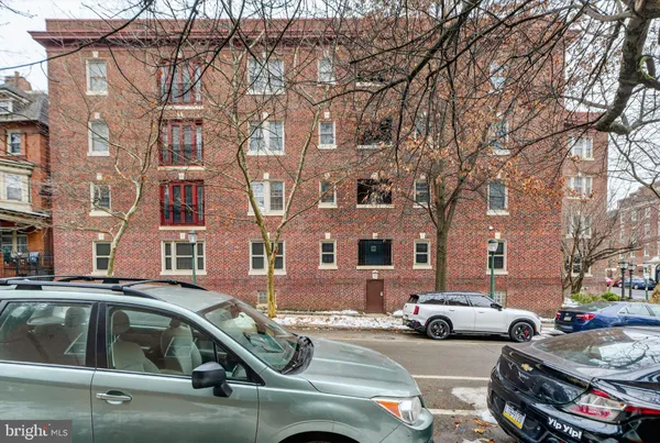 a view of a cars park in front of a building